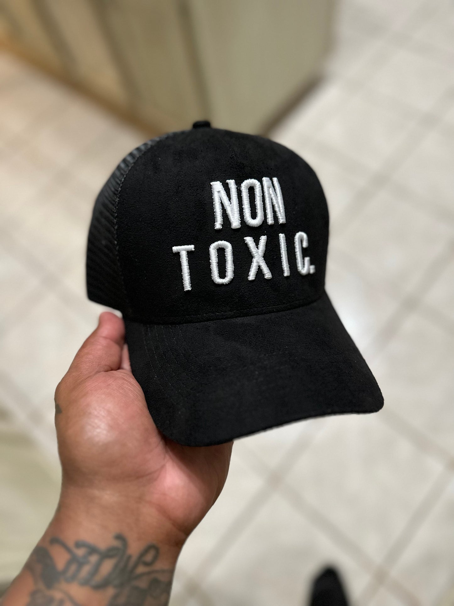 Black suede “NON TOXIC” trucker